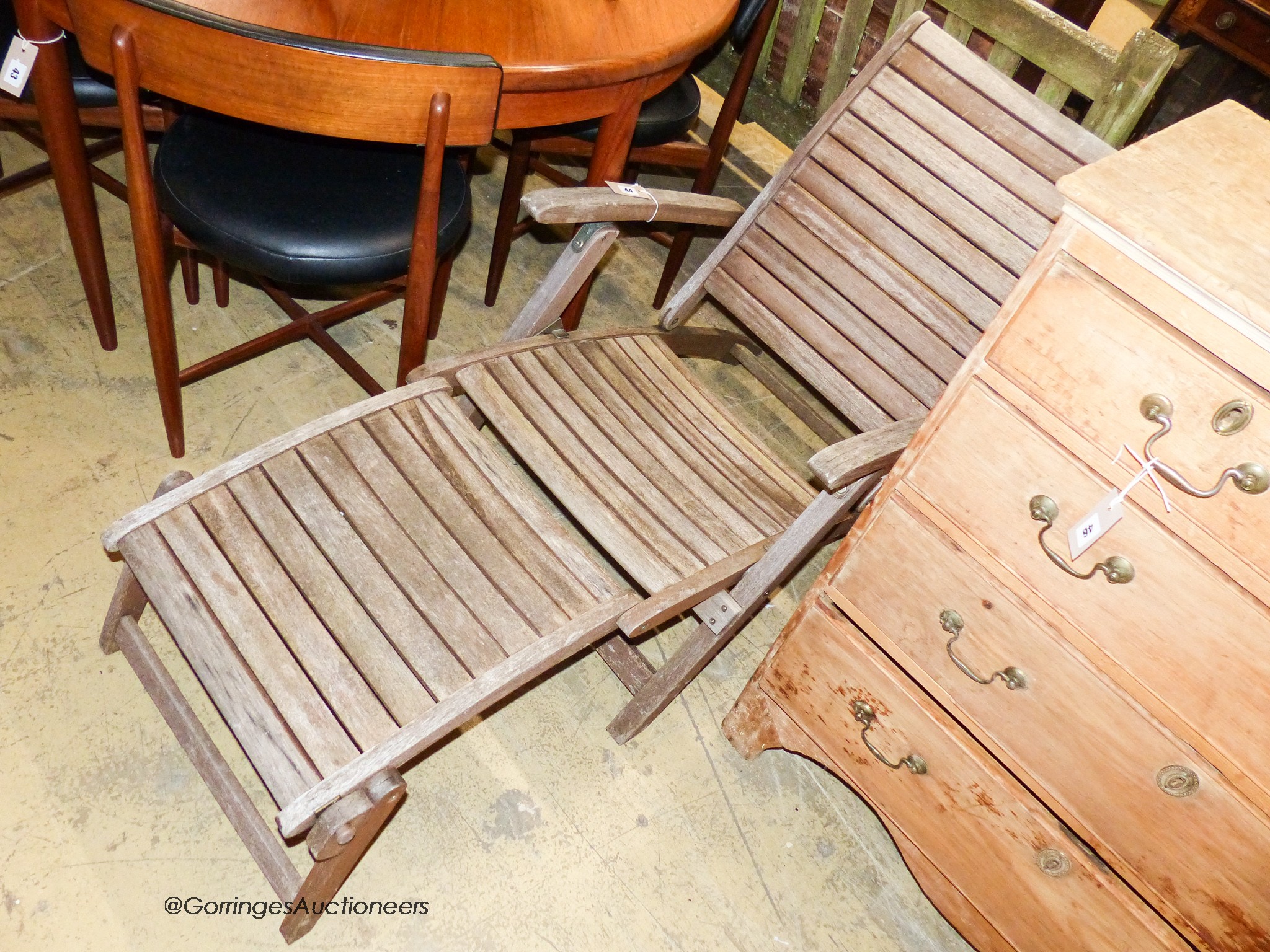 A weathered teak folding garden steamer chair